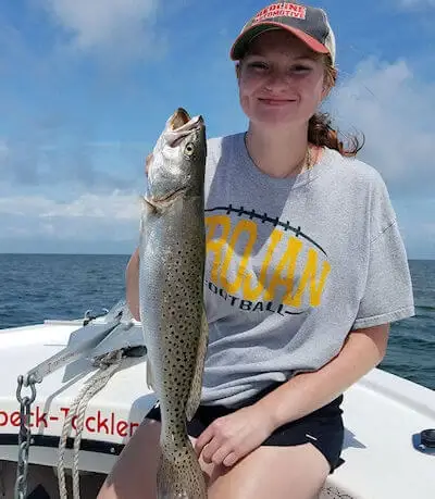 Young Lady with Hatteras Island Speckled Trout. Young lady hold a Hatteras Island Speckled Trout she caught.
