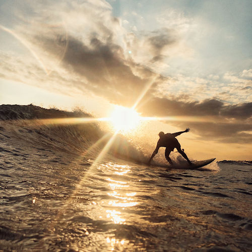 Surfing at sunset.